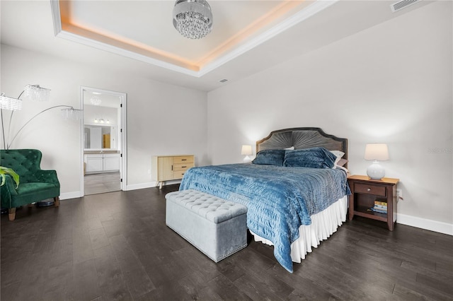 1084 NW 134th Way, Newberry, FL 32669 - bedroom with a tray ceiling, wood finished floors, baseboards, ensuite bath, and ornamental molding