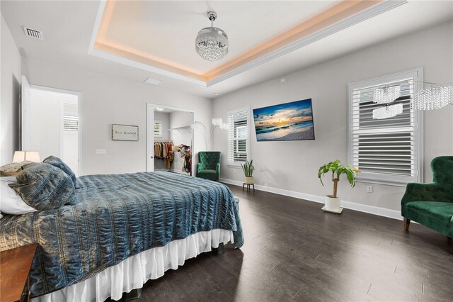 1084 NW 134th Way, Newberry, FL 32669 - bedroom featuring a raised ceiling, wood finished floors, and baseboards