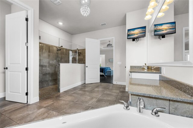 1084 NW 134th Way, Newberry, FL 32669 - ensuite bathroom featuring tiled shower, a chandelier, vanity, baseboards, and a tub