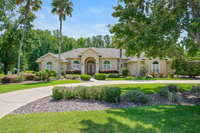 3533 SW 87th Dr, Gainesville, FL 32608 - view of front of property with french doors, stucco siding, and a front yard