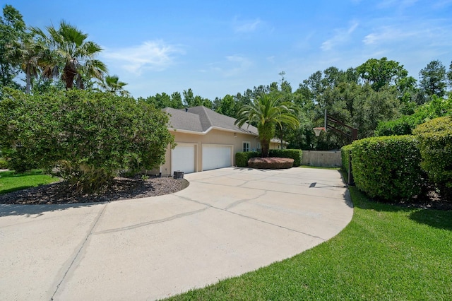 3533 SW 87th Dr, Gainesville, FL 32608 - view of home's exterior with an attached garage, driveway, and stucco siding