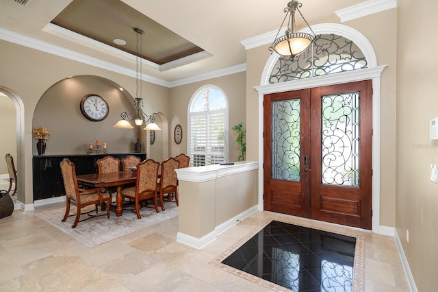 3533 SW 87th Dr, Gainesville, FL 32608 - foyer featuring ornamental molding, baseboards, arched walkways, french doors, and a tray ceiling