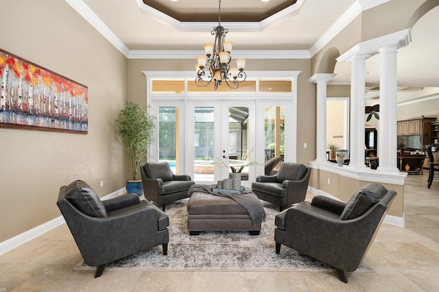 3533 SW 87th Dr, Gainesville, FL 32608 - living room featuring ornate columns, a chandelier, crown molding, a tray ceiling, and french doors