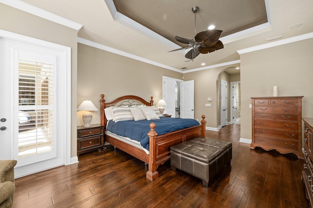 3533 SW 87th Dr, Gainesville, FL 32608 - bedroom featuring a raised ceiling, dark wood-type flooring, arched walkways, crown molding, and baseboards