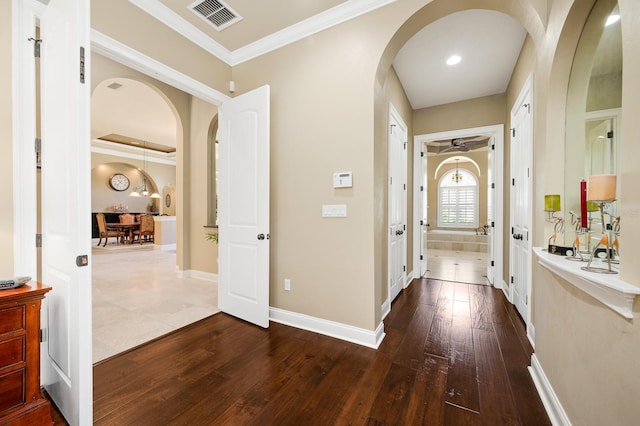 3533 SW 87th Dr, Gainesville, FL 32608 - entrance foyer featuring arched walkways, dark wood-style flooring, baseboards, and crown molding