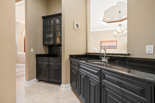 3533 SW 87th Dr, Gainesville, FL 32608 - bar with a sink, a chandelier, crown molding, a tray ceiling, and baseboards