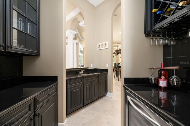 3533 SW 87th Dr, Gainesville, FL 32608 - bar with arched walkways, a sink, decorative columns, and baseboards