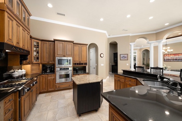 3533 SW 87th Dr, Gainesville, FL 32608 - kitchen with stainless steel appliances, decorative columns, brown cabinets, arched walkways, and ornamental molding