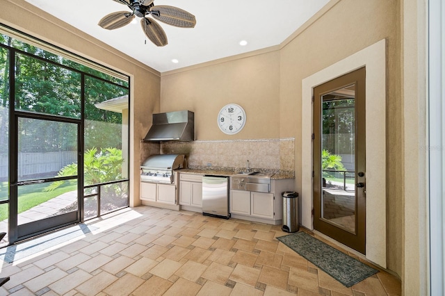 3533 SW 87th Dr, Gainesville, FL 32608 - kitchen with refrigerator, wall chimney range hood, white cabinets, a ceiling fan, and decorative backsplash