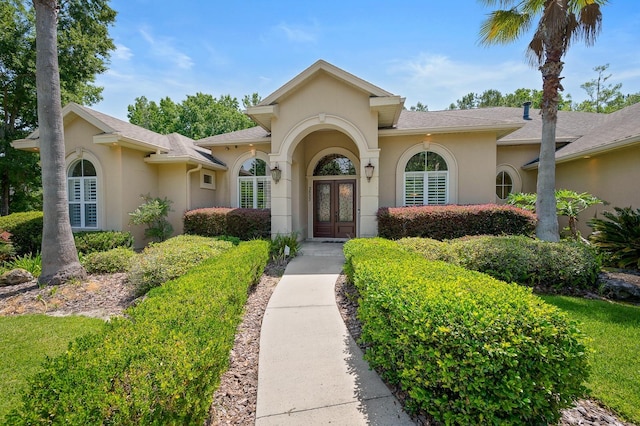 3533 SW 87th Dr, Gainesville, FL 32608 - doorway to property with french doors, stucco siding, and a shingled roof