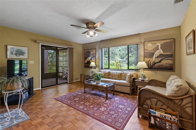 8689 NW 42nd Dr, Gainesville, FL 32653 - living area featuring plenty of natural light, ceiling fan, and baseboards