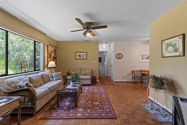 8689 NW 42nd Dr, Gainesville, FL 32653 - living room featuring a ceiling fan, wallpapered walls, and baseboards