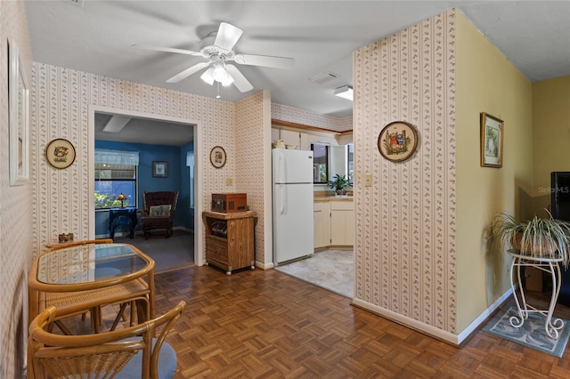 8689 NW 42nd Dr, Gainesville, FL 32653 - kitchen featuring freestanding refrigerator, wallpapered walls, baseboards, and ceiling fan