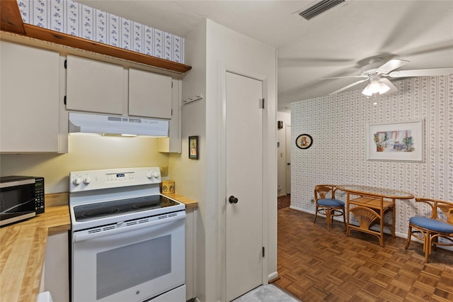 8689 NW 42nd Dr, Gainesville, FL 32653 - kitchen featuring white electric stove, under cabinet range hood, wallpapered walls, stainless steel microwave, and a ceiling fan