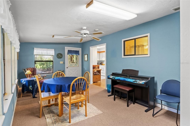 8689 NW 42nd Dr, Gainesville, FL 32653 - dining space featuring carpet flooring and a ceiling fan