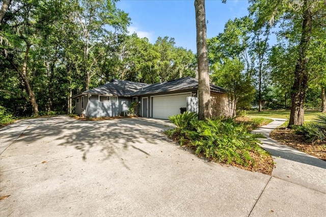 view of property exterior featuring driveway and an attached garage