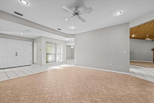 unfurnished living room featuring a ceiling fan, recessed lighting, baseboards, and tile patterned floors