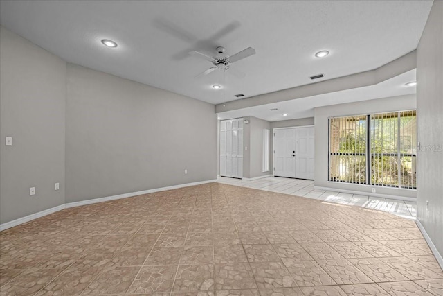 spare room with baseboards, ceiling fan, and recessed lighting