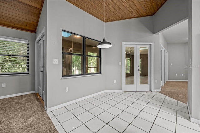 unfurnished room with wood ceiling, plenty of natural light, lofted ceiling, baseboards, and french doors