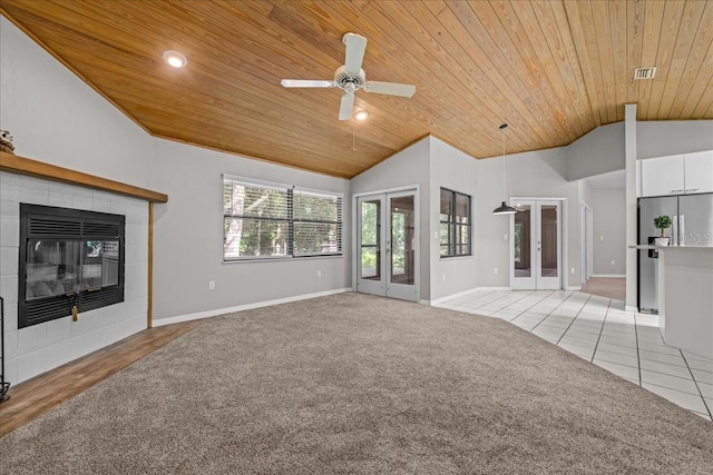 unfurnished living room featuring wooden ceiling, french doors, vaulted ceiling, baseboards, and light carpet