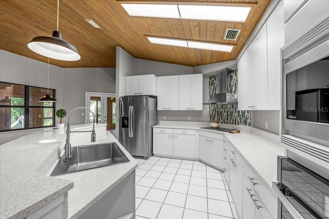 kitchen featuring wall chimney exhaust hood, appliances with stainless steel finishes, a sink, wooden ceiling, and light tile patterned flooring