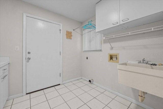 laundry area featuring cabinet space, electric dryer hookup, washer hookup, and baseboards