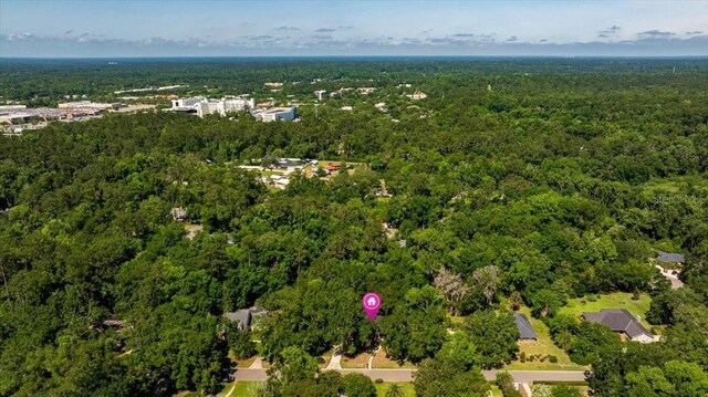 aerial view of property's location with a forest