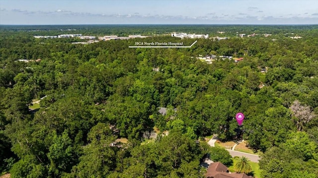 view of property location with a heavily wooded area