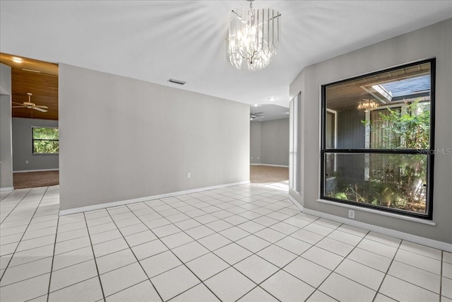 1326 NW 57th St, Gainesville, FL 32605 - spare room featuring baseboards, a chandelier, and light tile patterned floors
