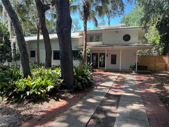 rear view of house with a porch and driveway