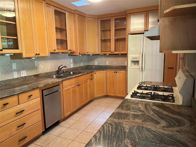 kitchen with a sink, white refrigerator with ice dispenser, dishwasher, light tile patterned floors, and range