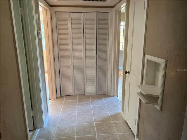 hall featuring light tile patterned flooring