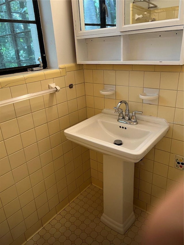 bathroom featuring tile walls and a wainscoted wall