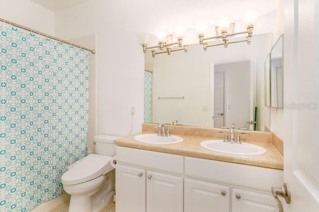 bathroom featuring toilet, double vanity, tile patterned floors, and a shower with curtain