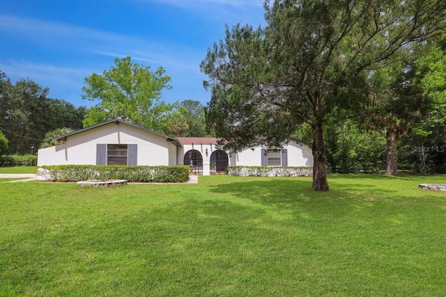 8804 NW 176th Ter, Alachua, FL 32615 - view of front facade featuring stucco siding and a front yard