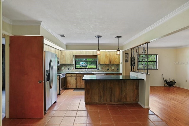 8804 NW 176th Ter, Alachua, FL 32615 - kitchen featuring plenty of natural light, stainless steel appliances, decorative backsplash, tile patterned flooring, and ornamental molding