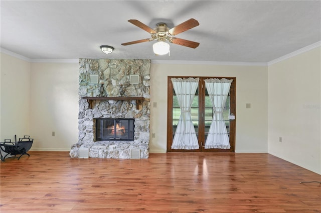 8804 NW 176th Ter, Alachua, FL 32615 - living room with wood finished floors, crown molding, ceiling fan, a fireplace, and baseboards