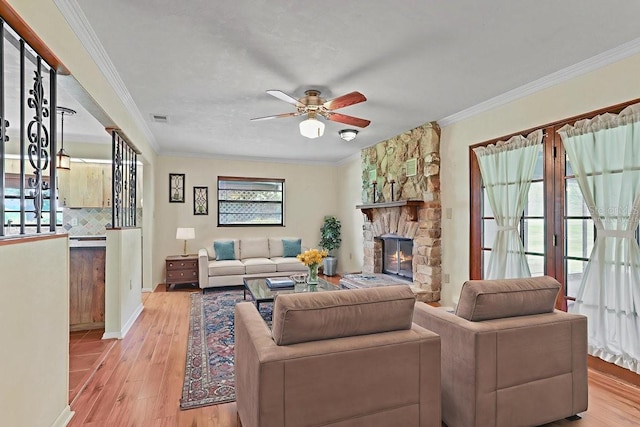 8804 NW 176th Ter, Alachua, FL 32615 - living area with wood finished floors, ceiling fan, ornamental molding, a fireplace, and baseboards