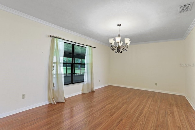 8804 NW 176th Ter, Alachua, FL 32615 - spare room with a chandelier, wood finished floors, crown molding, and baseboards