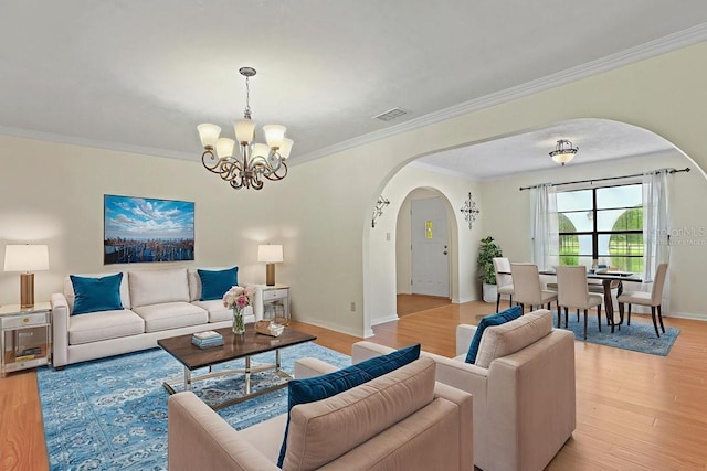 8804 NW 176th Ter, Alachua, FL 32615 - living area with arched walkways, a chandelier, light wood-style floors, crown molding, and baseboards