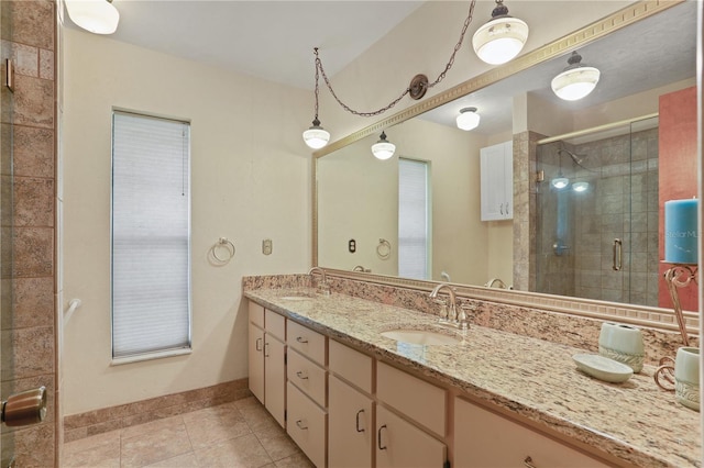 8804 NW 176th Ter, Alachua, FL 32615 - bathroom featuring double vanity, a shower stall, tile patterned floors, and baseboards