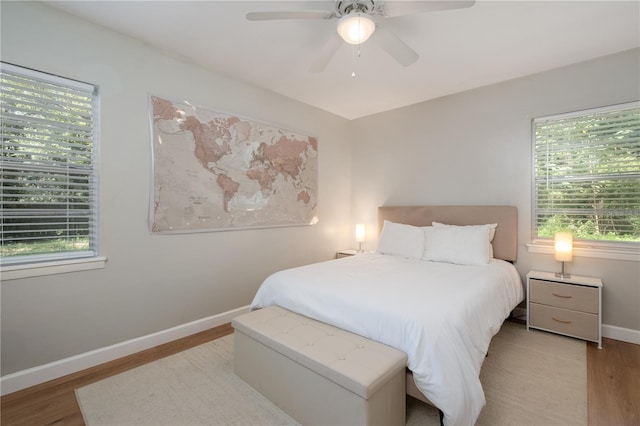4502 SW 47th Way, Gainesville, FL 32608 - bedroom featuring wood finished floors, multiple windows, baseboards, and ceiling fan