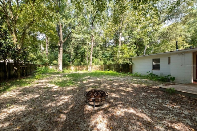 4502 SW 47th Way, Gainesville, FL 32608 - fenced backyard featuring a fire pit and a wooden deck