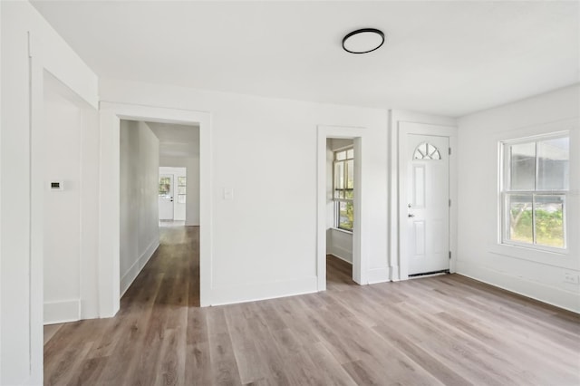 20014 SE 219th Ave, Hawthorne, FL 32640 - unfurnished bedroom with wood finished floors, multiple windows, and baseboards