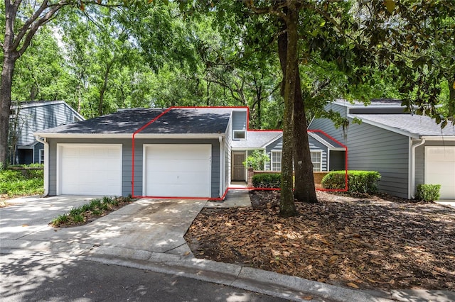 231 NW 48th Blvd Unit 0, Gainesville, FL 32607 - view of front of house with an attached garage, driveway, and roof with shingles