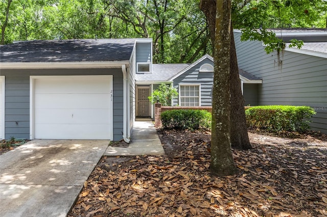 231 NW 48th Blvd Unit 0, Gainesville, FL 32607 - mid-century modern home featuring a shingled roof, driveway, and an attached garage