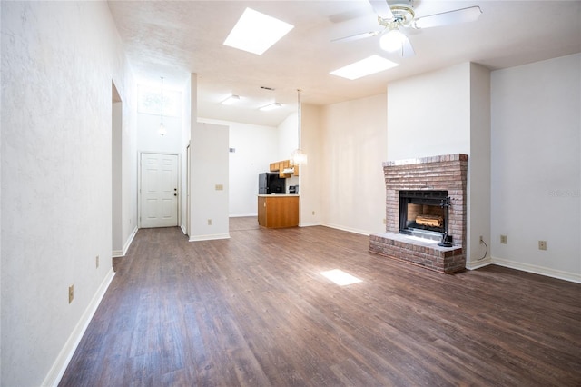 231 NW 48th Blvd Unit 0, Gainesville, FL 32607 - unfurnished living room with a fireplace, dark wood-style floors, ceiling fan, and baseboards