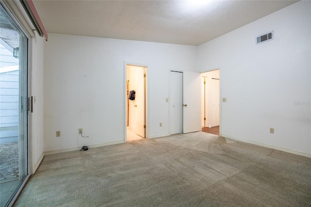 231 NW 48th Blvd Unit 0, Gainesville, FL 32607 - unfurnished bedroom with carpet, ensuite bath, and baseboards