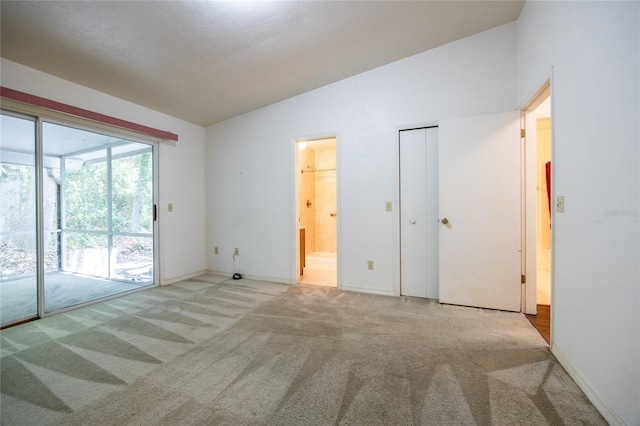 231 NW 48th Blvd Unit 0, Gainesville, FL 32607 - empty room featuring carpet floors, baseboards, and lofted ceiling