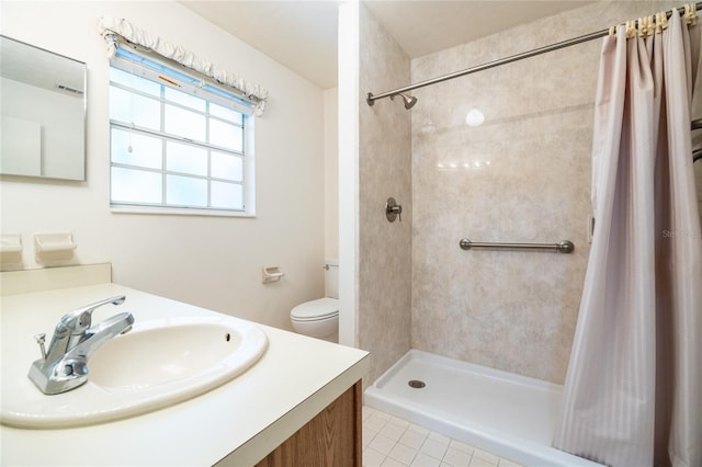 231 NW 48th Blvd Unit 0, Gainesville, FL 32607 - bathroom with vanity, tiled shower, tile patterned floors, and toilet
